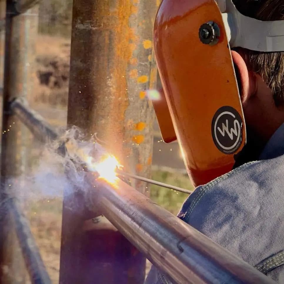 Matthew Bowker welding steel pipe on a Circle B job site