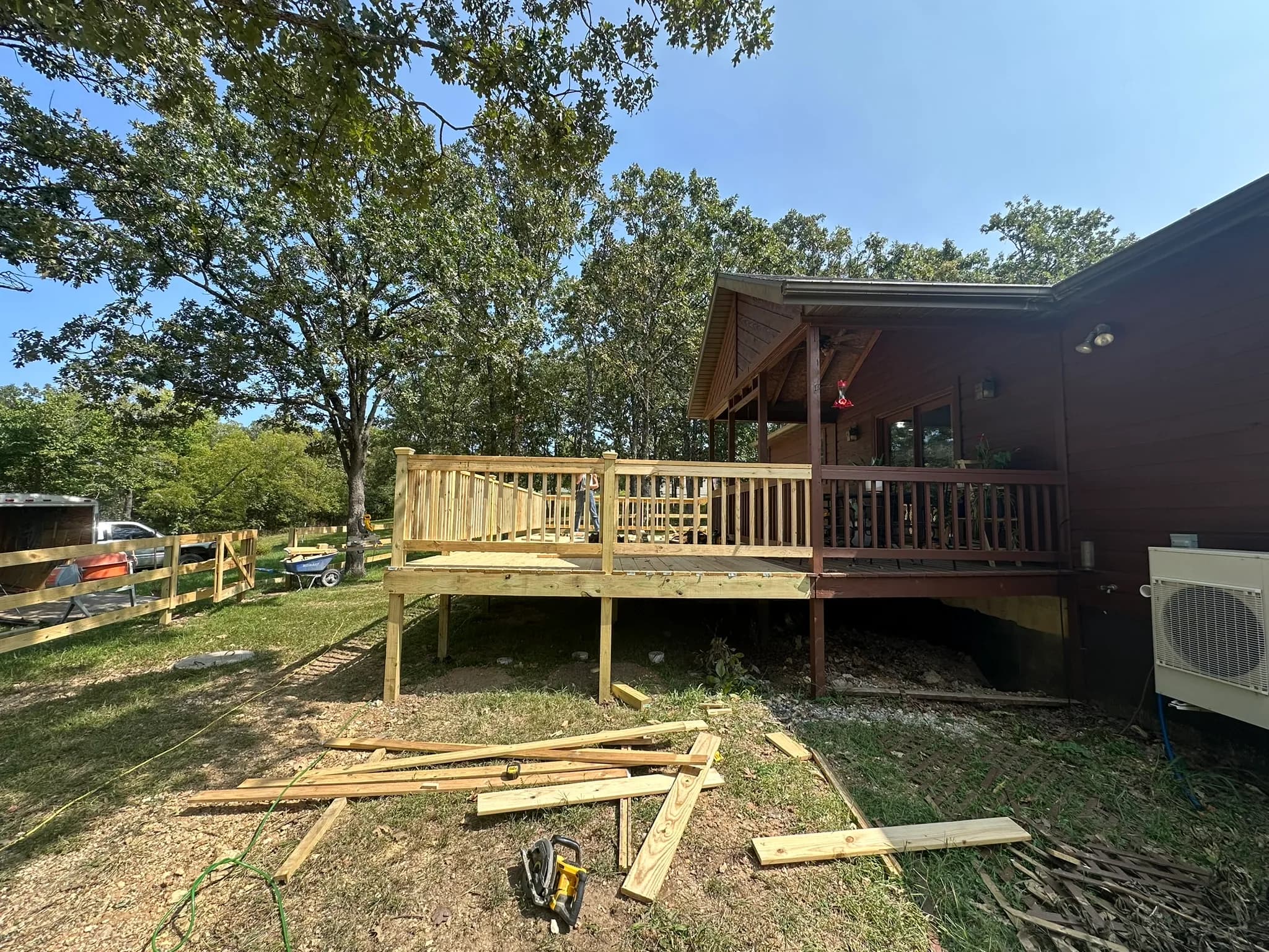 Completed wood deck addition with railing at a rural Missouri home