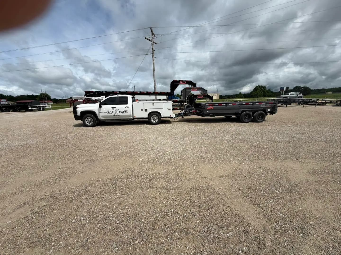 White truck hauling a flatbed trailer for local delivery work