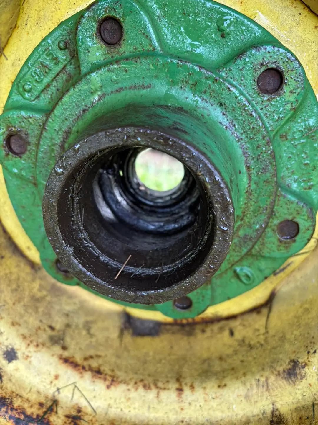 Close-up tractor hub repair with bearing exposed