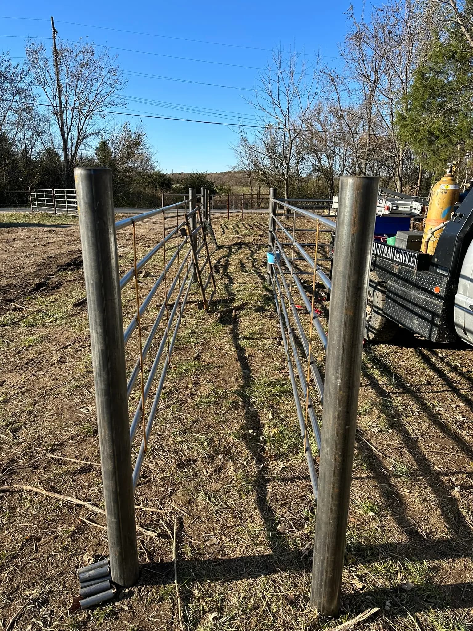 Pipe fence rails set between steel posts