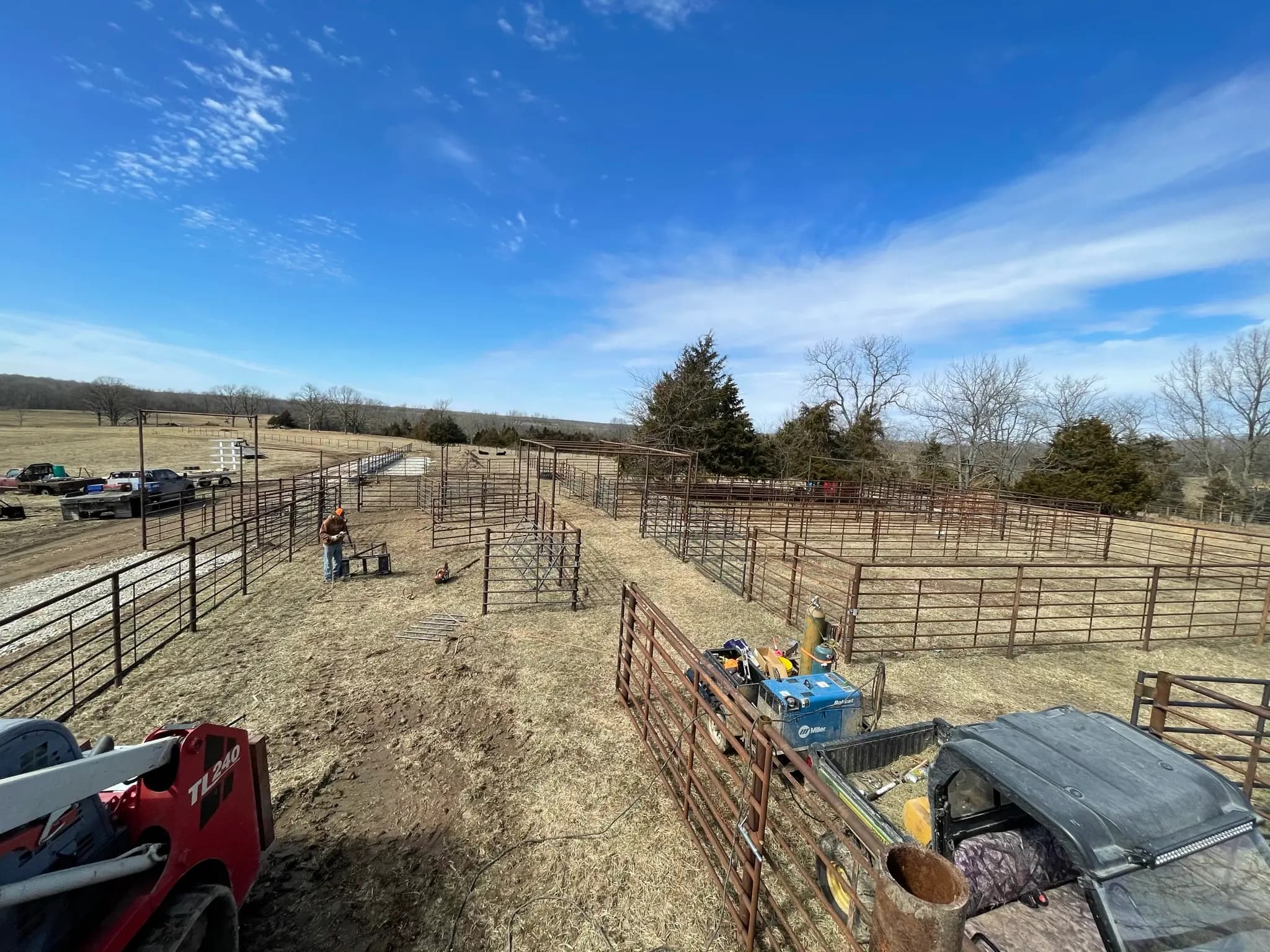 Farm corral fencing and pipe pens under a wide Missouri sky