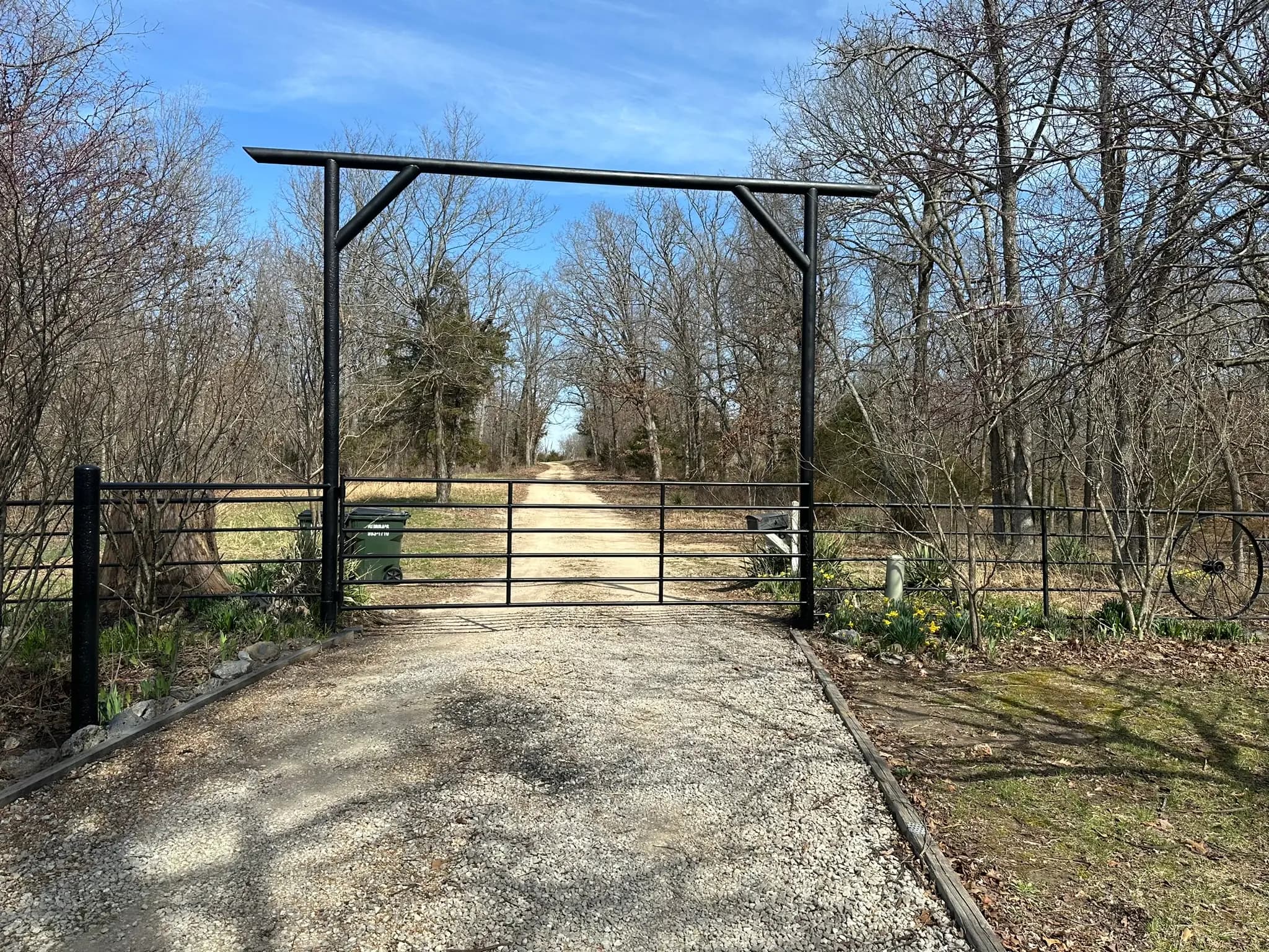 Pipe entrance gate framed between tall steel posts