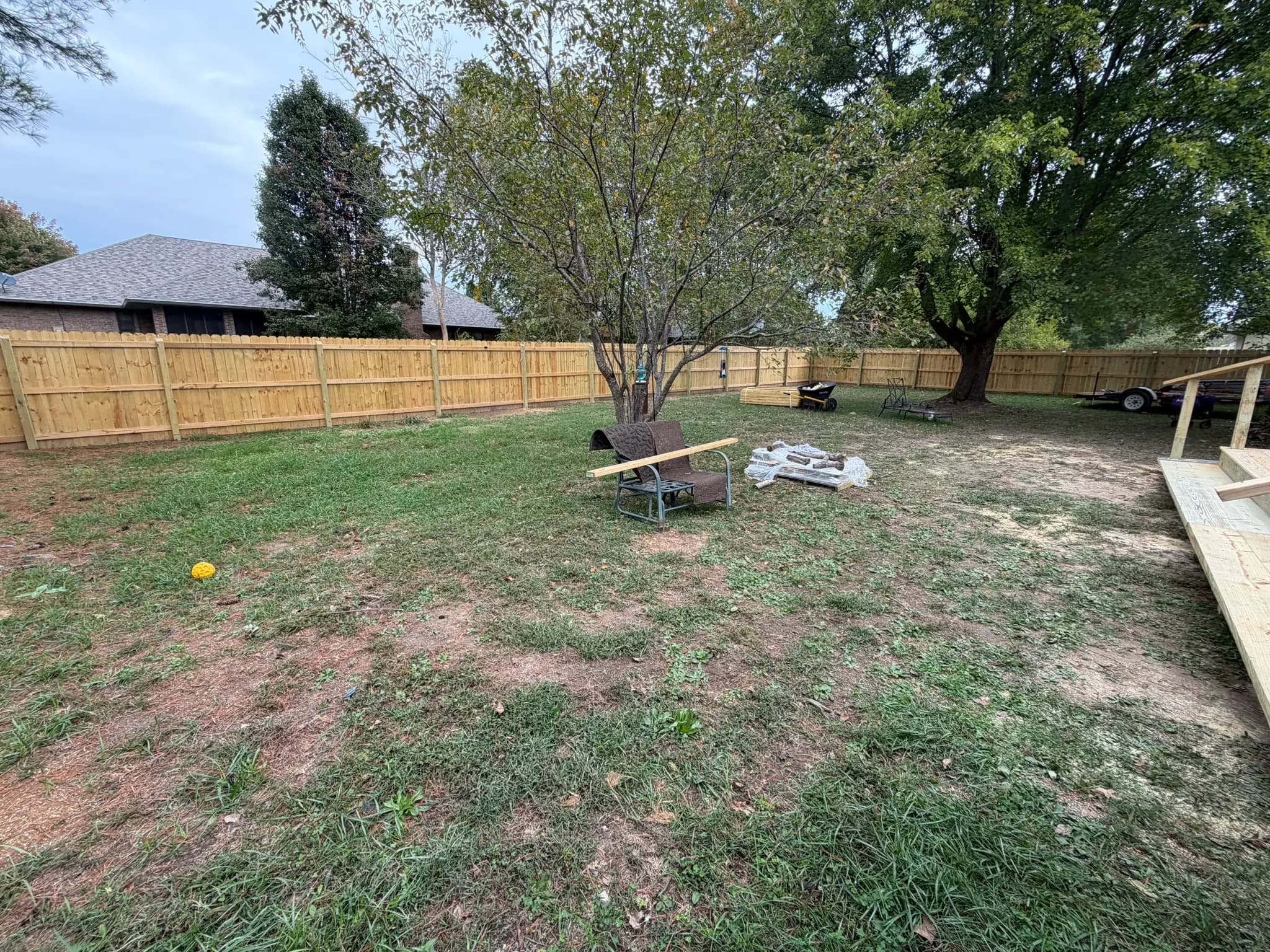Cedar privacy fence panels installed around a backyard