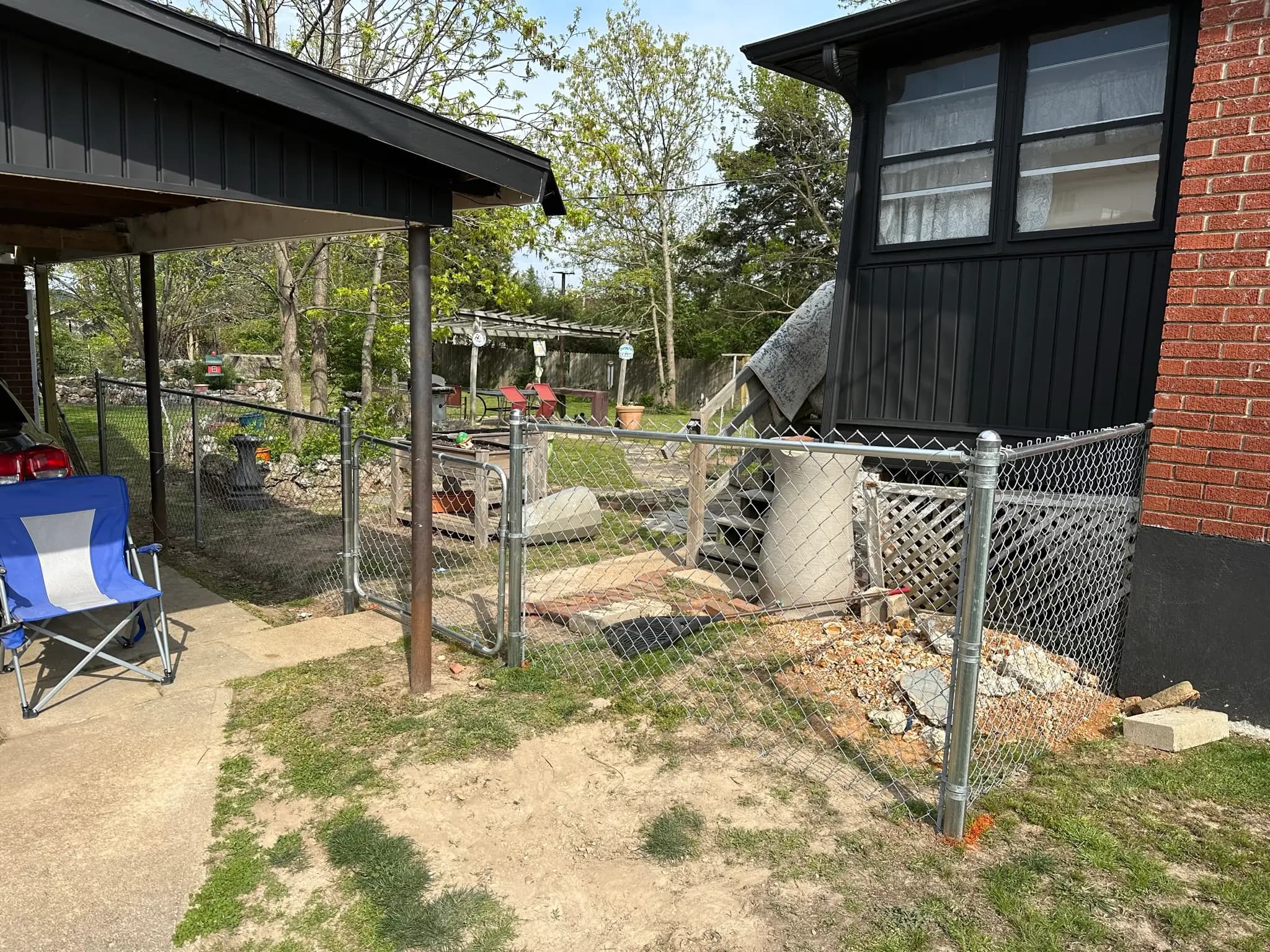 Chain link fence installed around a patio and porch