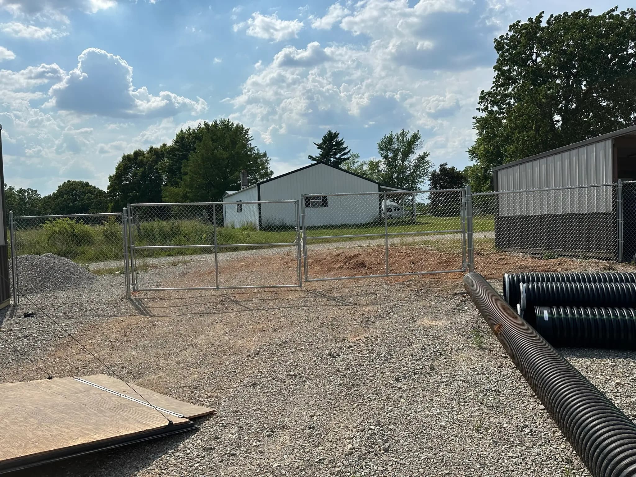 Chain link gate opening between buildings and gravel