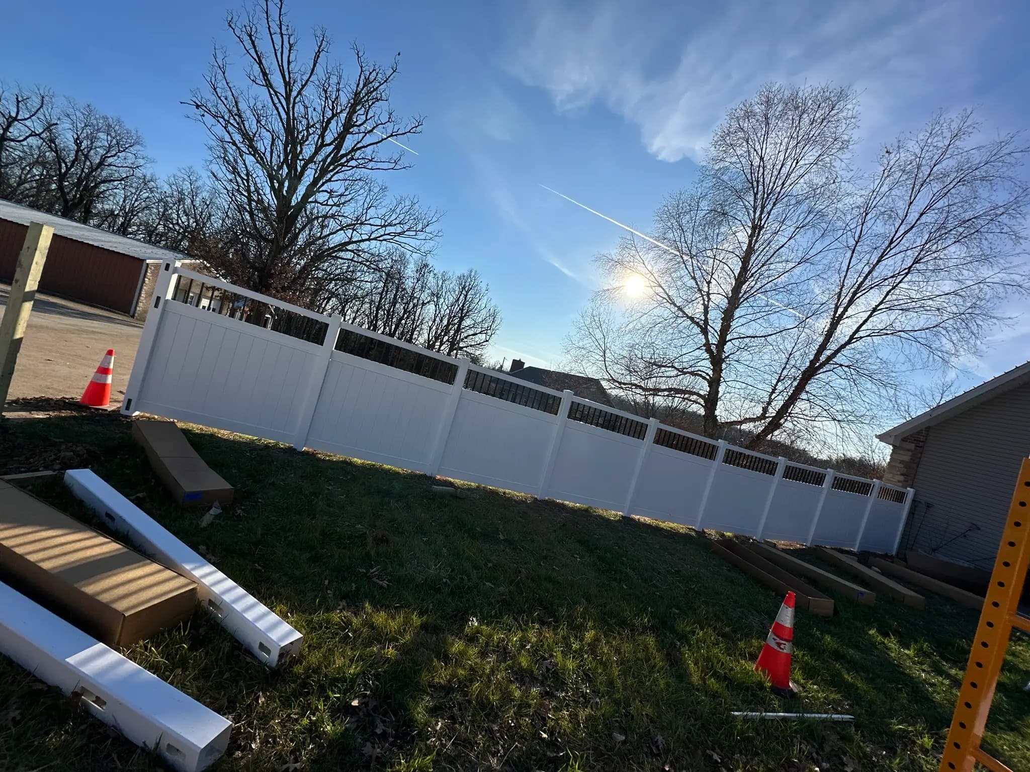 White vinyl privacy fence installed along a side yard