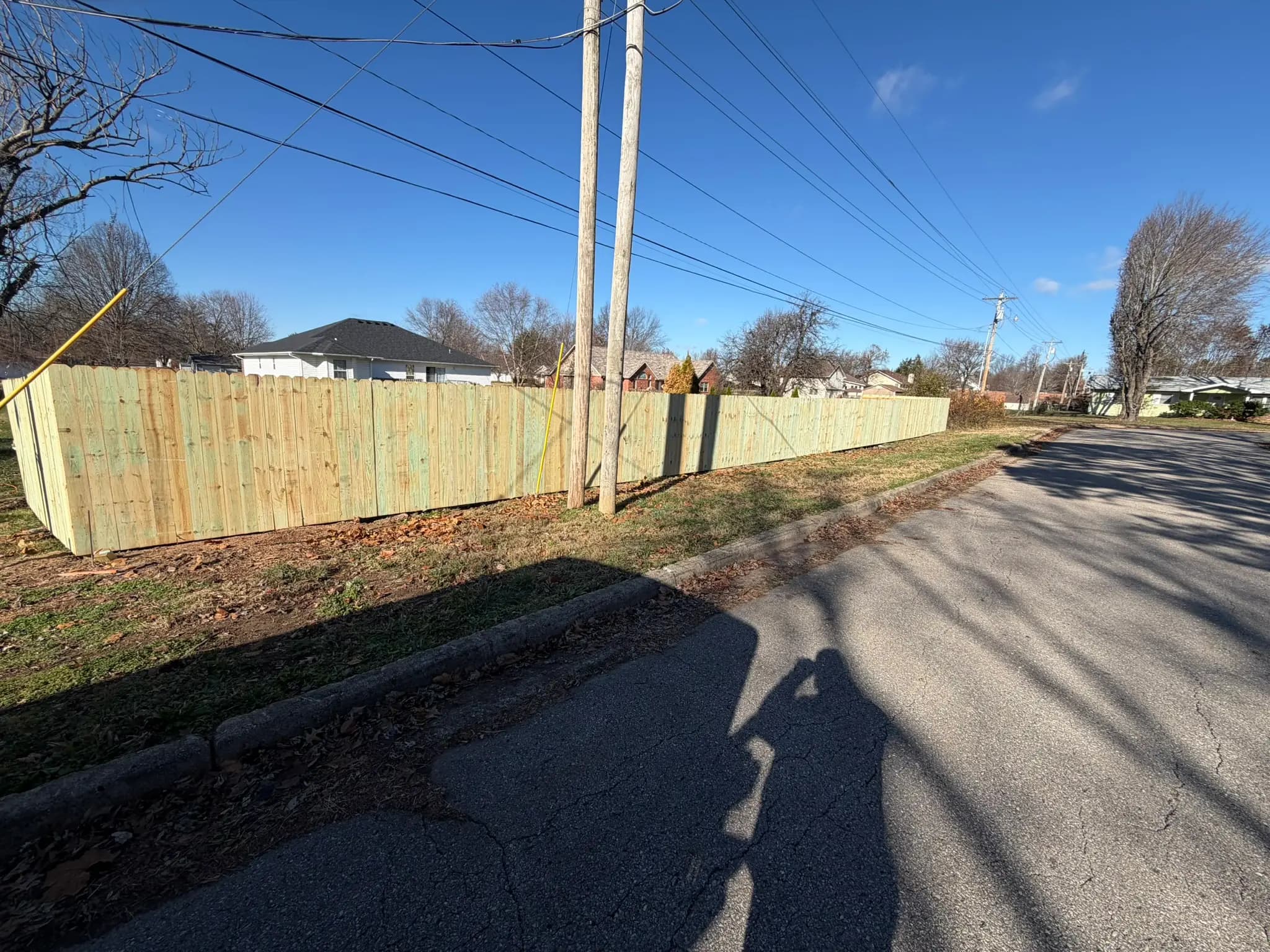 Wood privacy fence running along a Lebanon neighborhood street