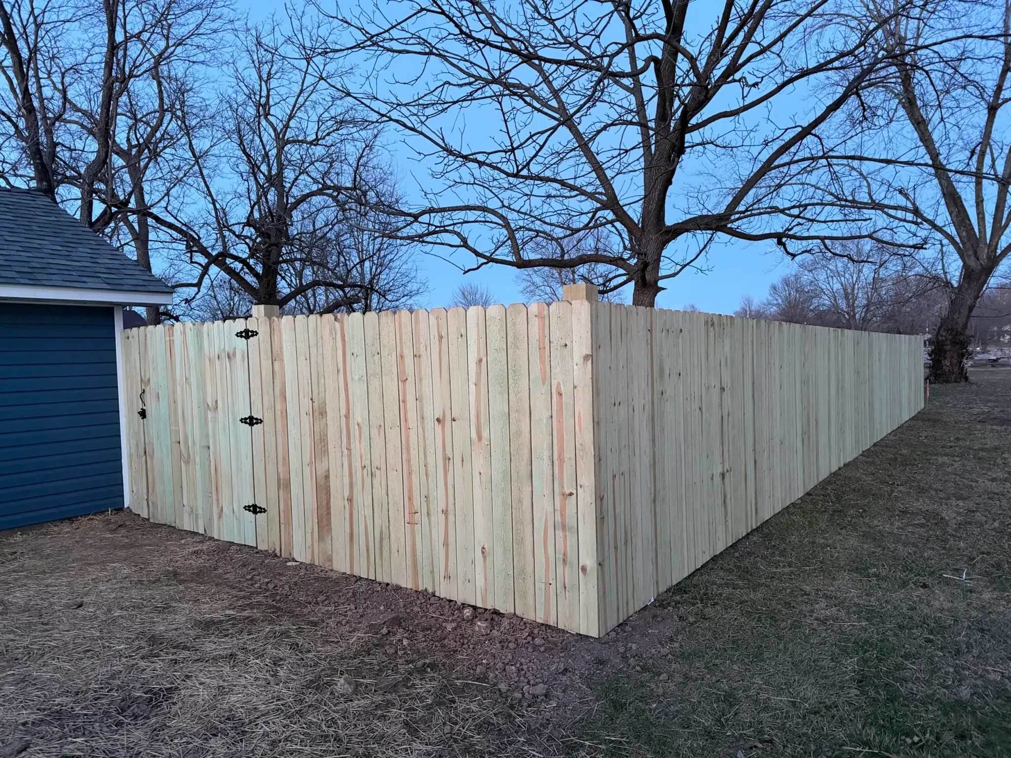 Wood privacy fence corner with walk-through gate