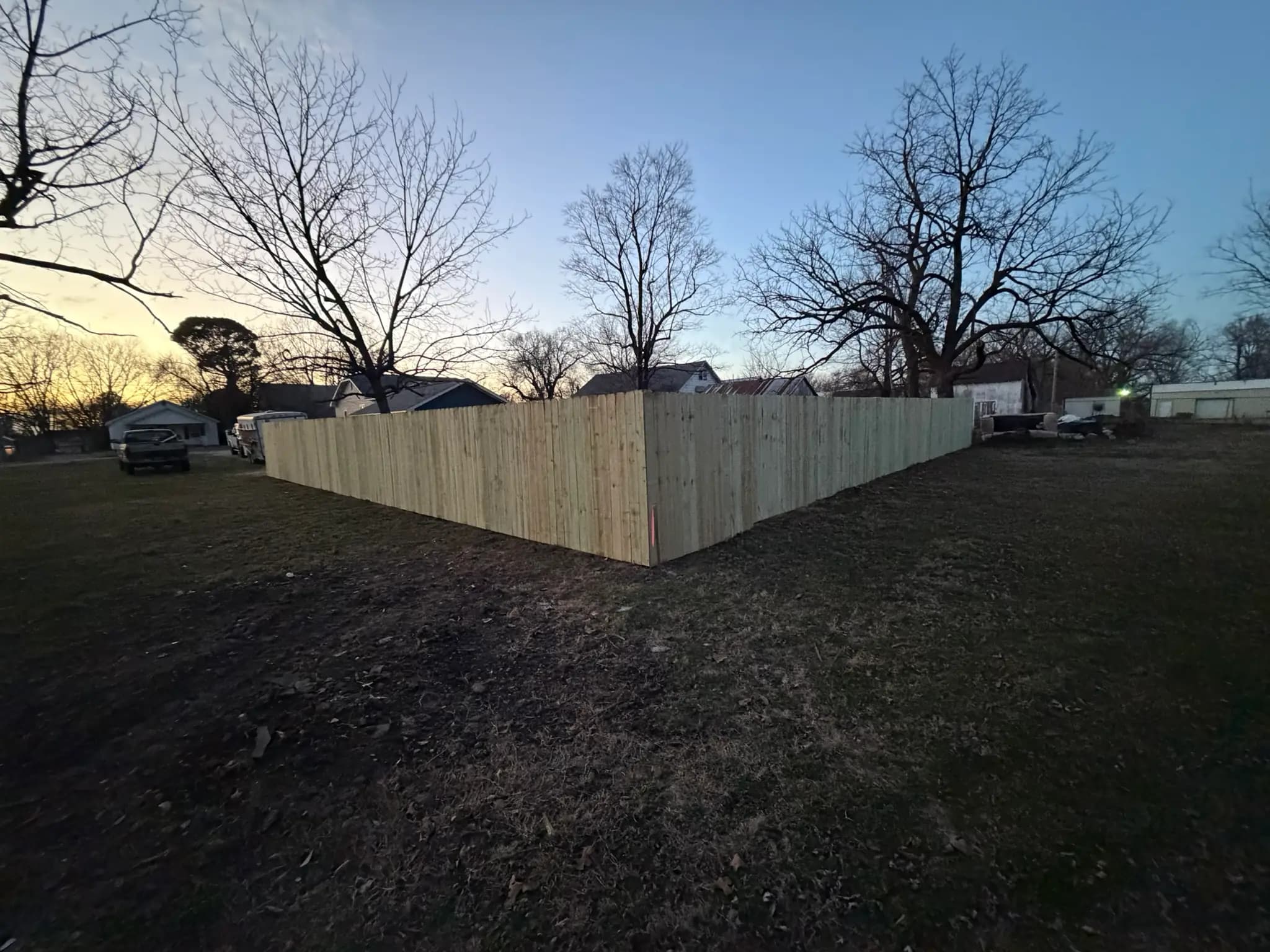 Tall wood privacy fence enclosing a side yard