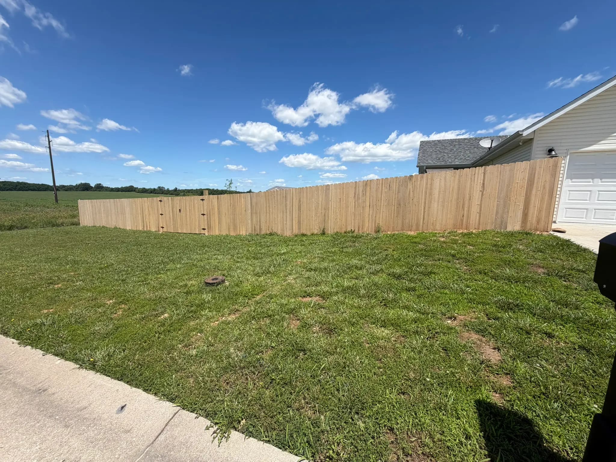 Long wood privacy fence behind a residential yard