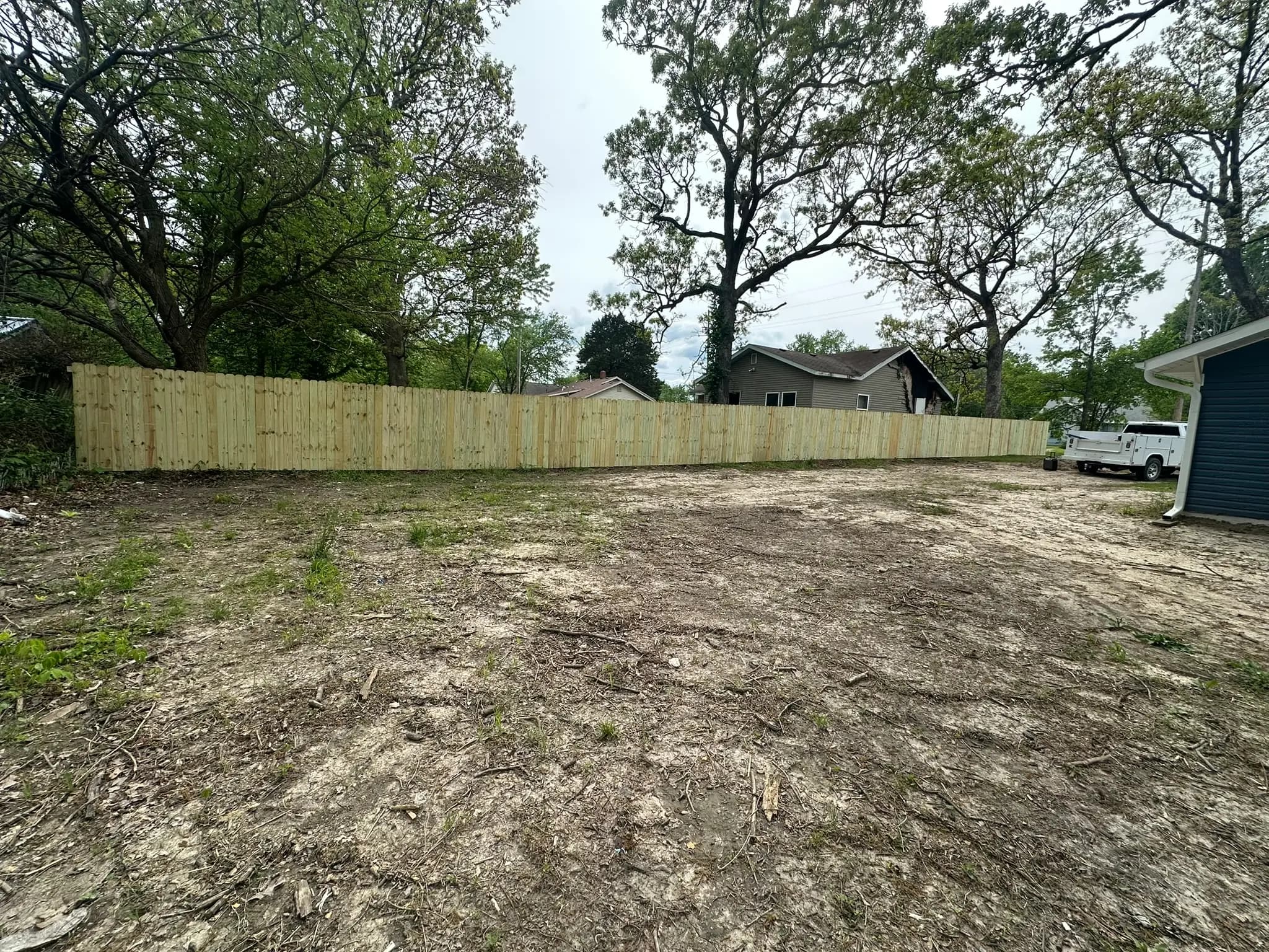 Wood privacy fence enclosing a gravel yard area