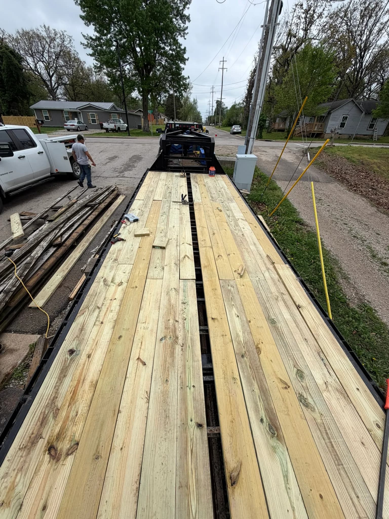 New pressure-treated boards installed on a flatbed equipment trailer
