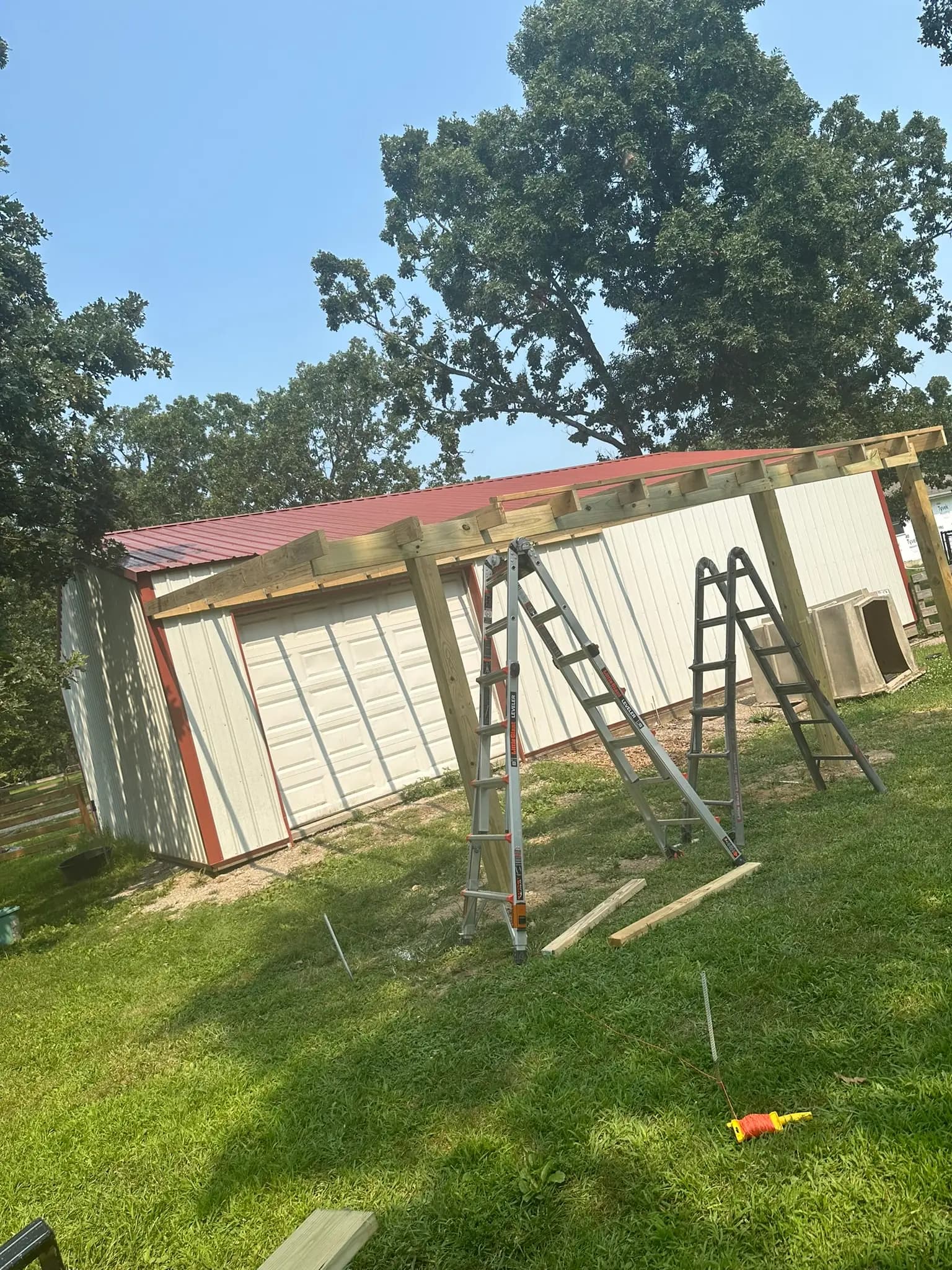 Outbuilding remodel with ladders and new roof trim