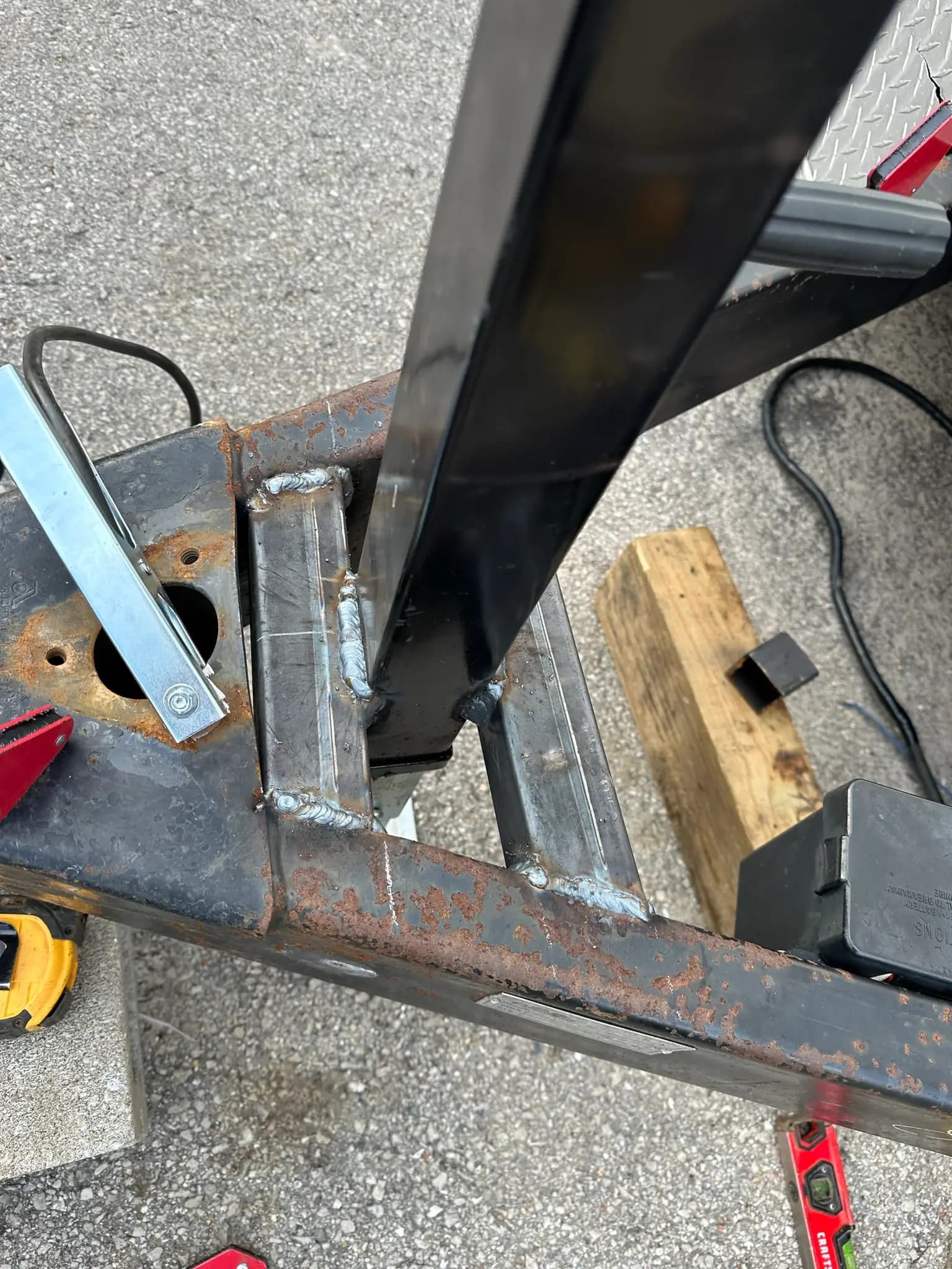 Close-up of welded steel bracket fabrication on a trailer