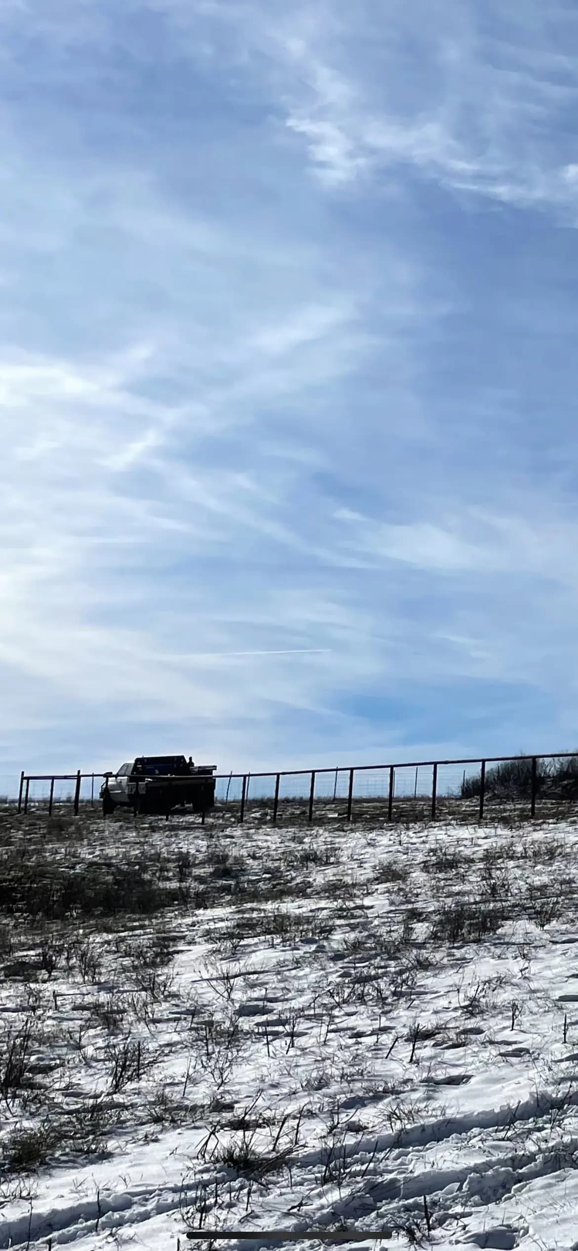 Long pipe fence line installed across open pasture