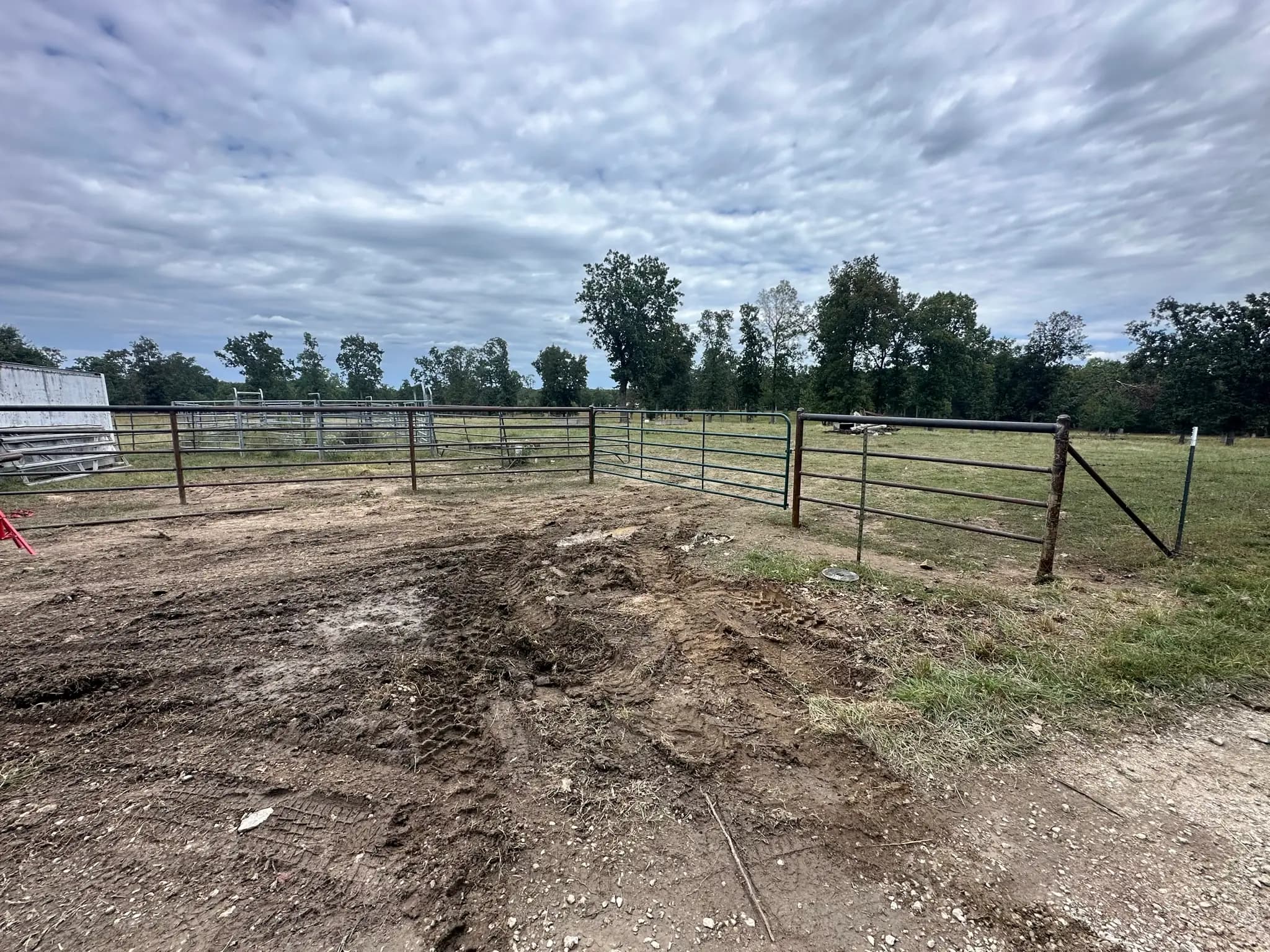Pipe fence and gate installation around a farm lot