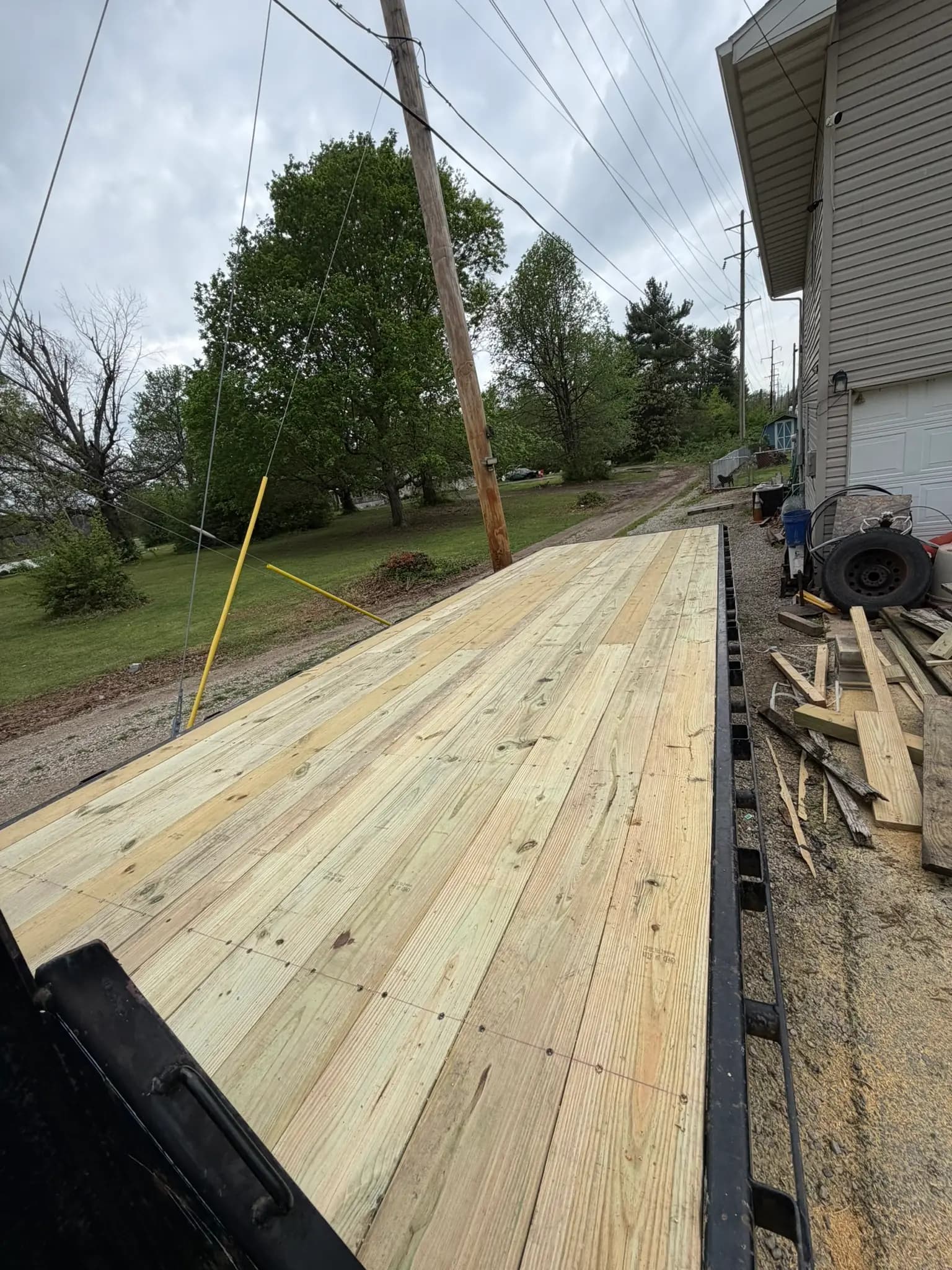 New pressure-treated deck boards installed beside a home